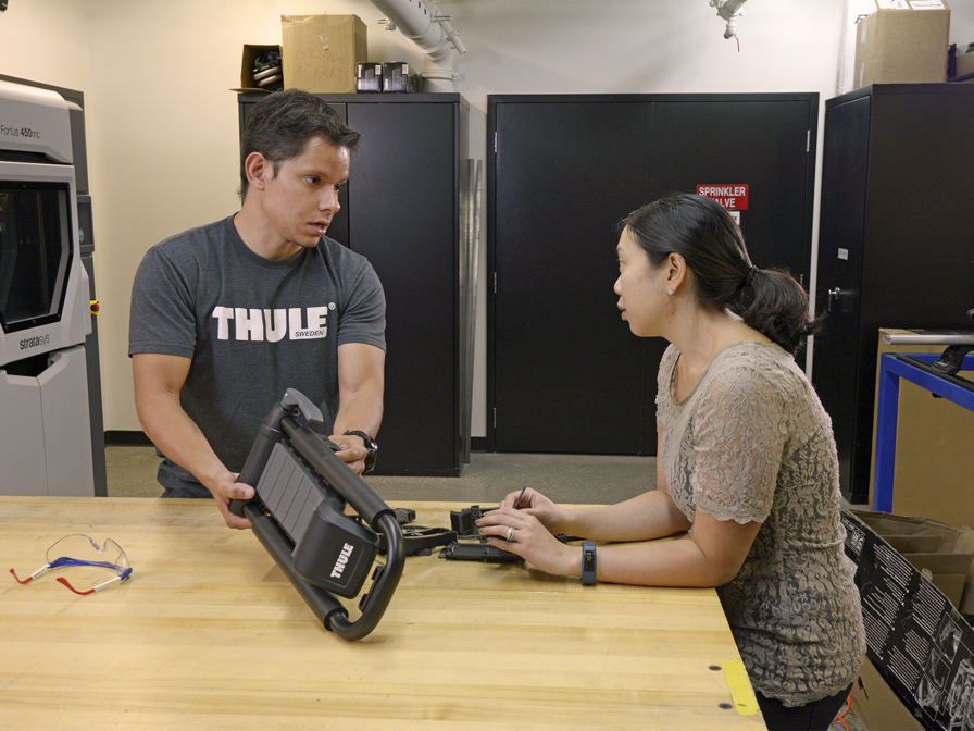 Two humans discussing a 3d printed part.