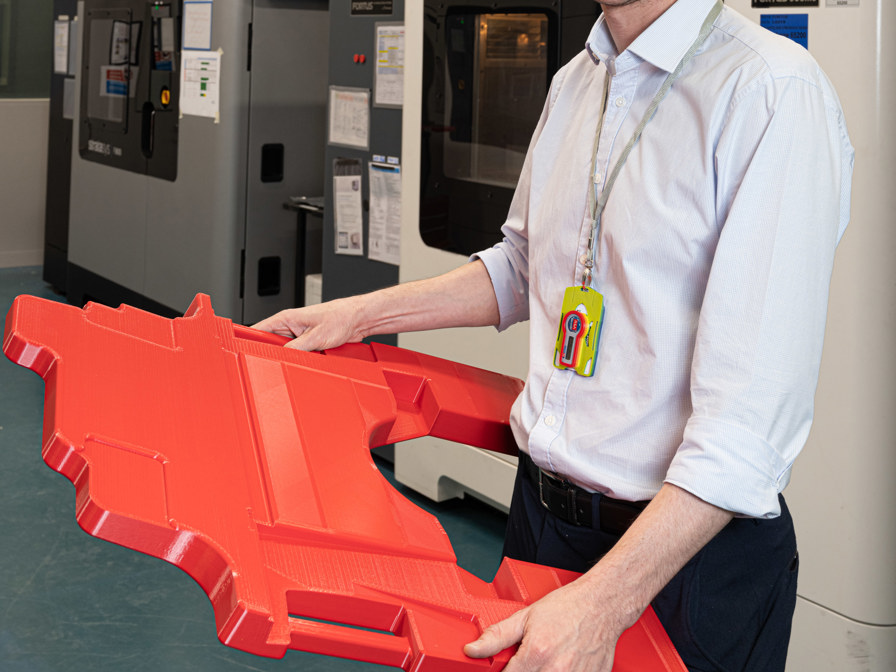 Greg Flanagan, pictured with a 3D printed Typhoon cockpit floor cover, says that Stratasys FDM additive manufacturing helps BAE Systems meet its overall company objectives to reduce costs and time-to-market.

