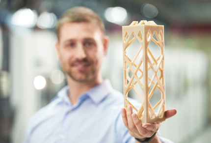 Man-holding-3d-printed-part-on-factory-floor