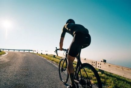 Man rides bike saddle 3D printed by DQBD.