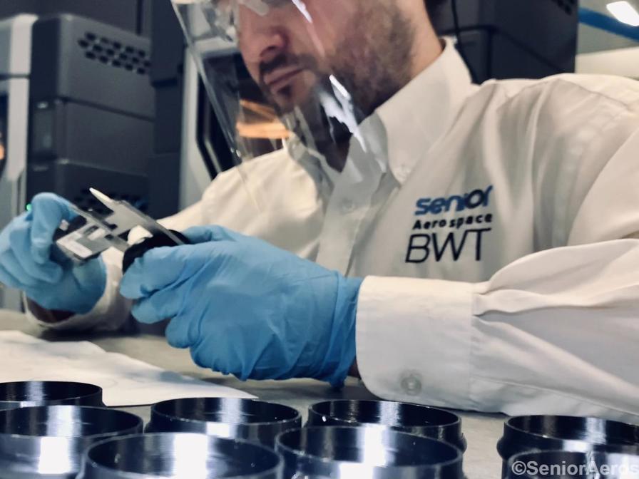 Lab worker measuring 3D printed piece