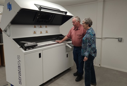 3D composites standing next to Stratasys printer