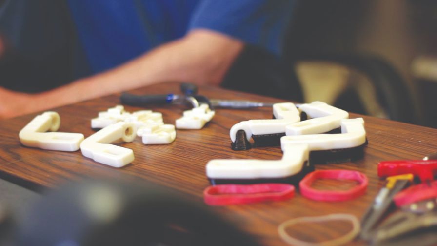 In his workshop in Nemours’ pediatric engineering
research lab, Whitney Sample has developed and 3D
printed custom WREX devices for 15 of his smallest
patients. Resistance bands relieve the force of gravity
on the arms, much like the springs on a swing-arm lamp
keep it suspended in air.