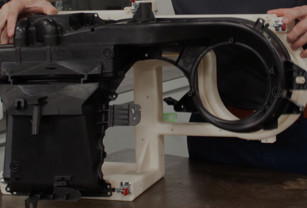 an engineer assembles a 3d printed automotive fixture for mahle