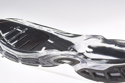 The opaque flexible material has been over-molded into the transparent rigid material. This was achieved via a single print.