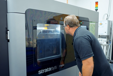 Person looks at Stratasys F900 3D Printer