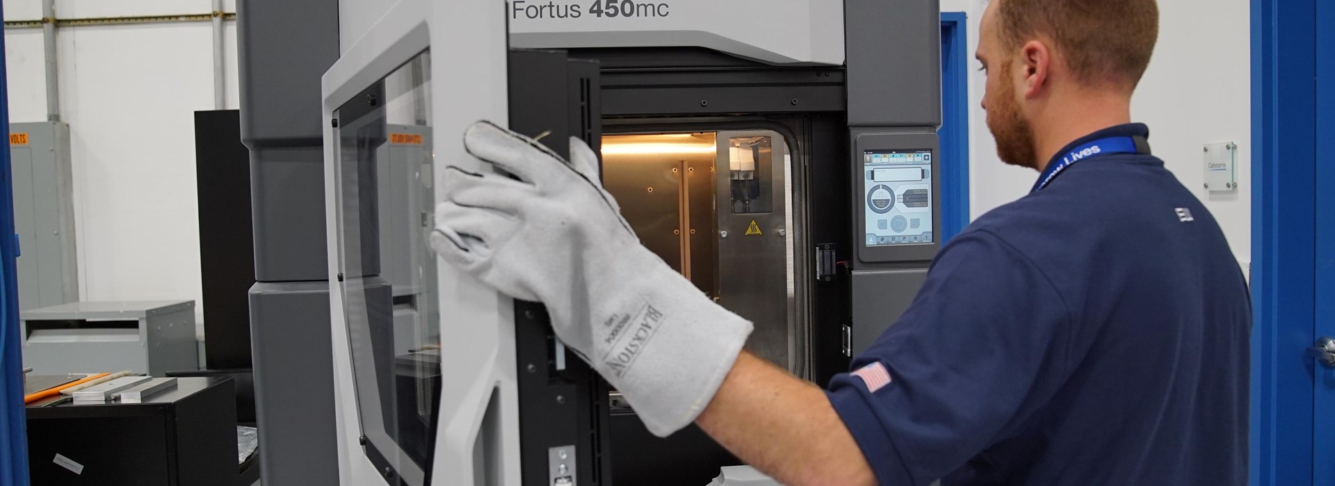 Worker closing Fortus 450mc 3D printer
