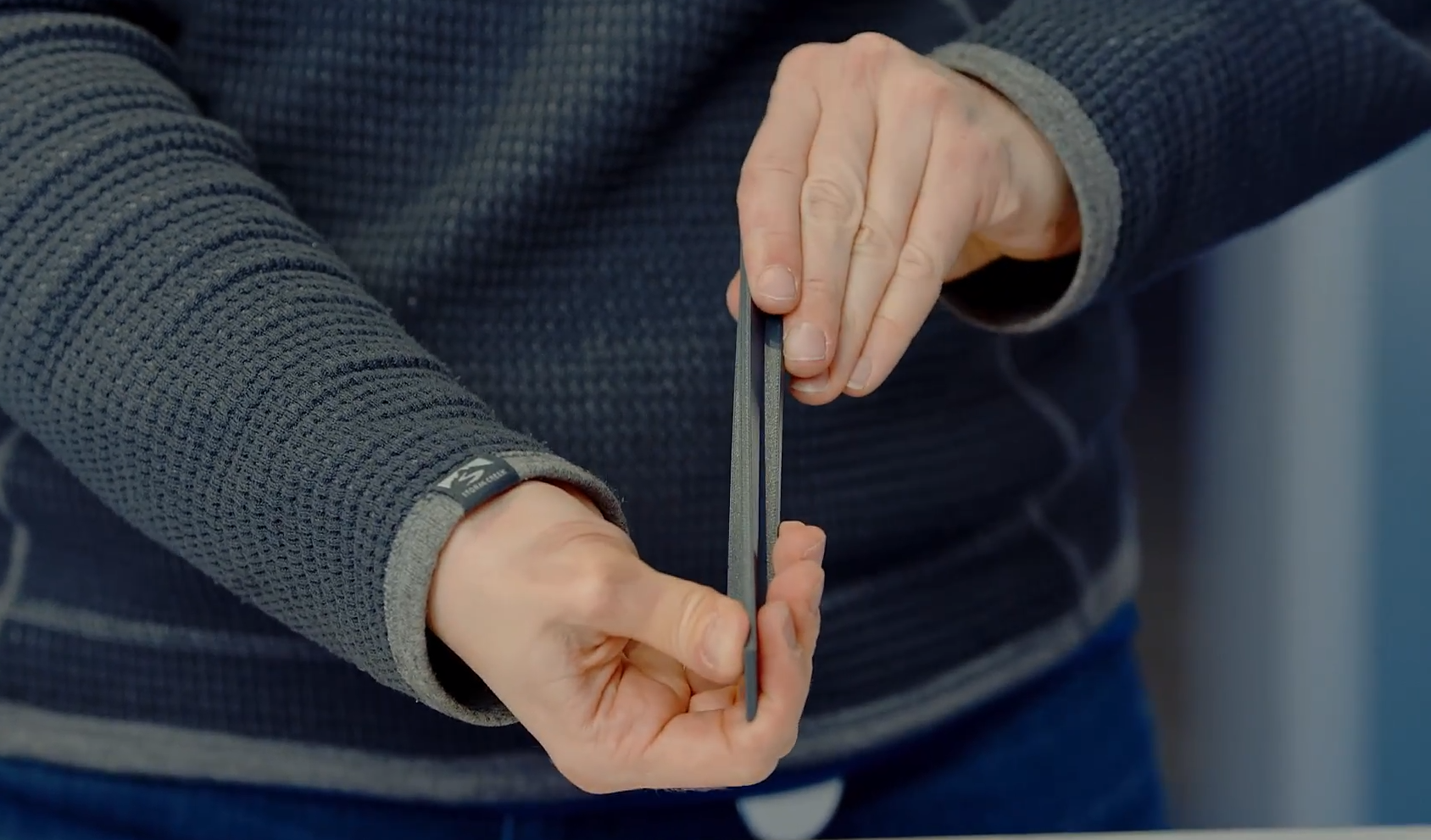 Man holding a 3D printed item to showcase the material.