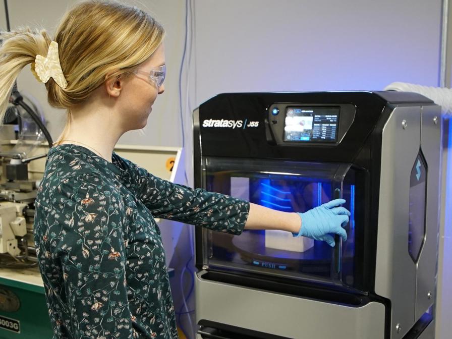 Woman using 3D printer