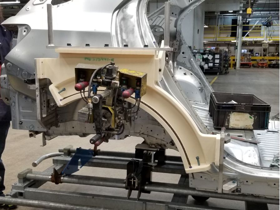 The wheel arch hemmer tool (ivory) made from ASA thermoplastic.