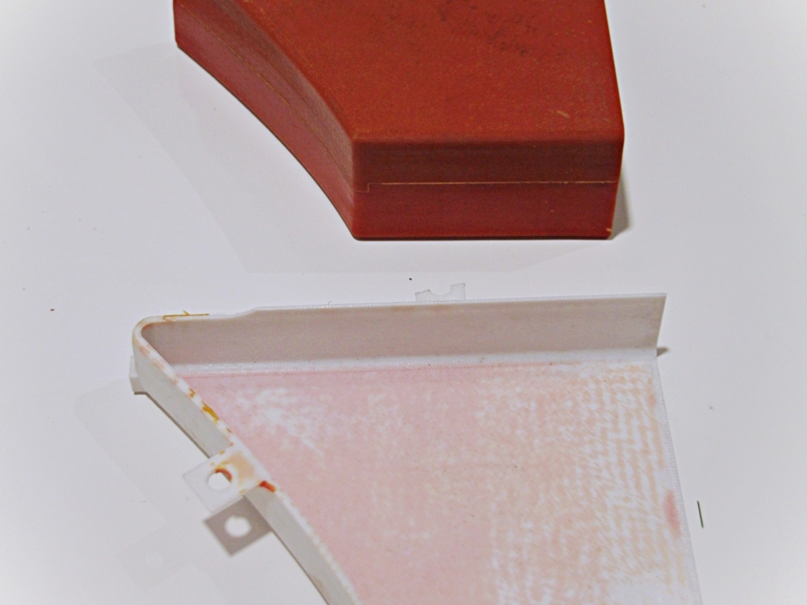 3D printed mold produced using Stratasys polycarbonate material, used to produce the polyurethane part in red for the automotive industry.