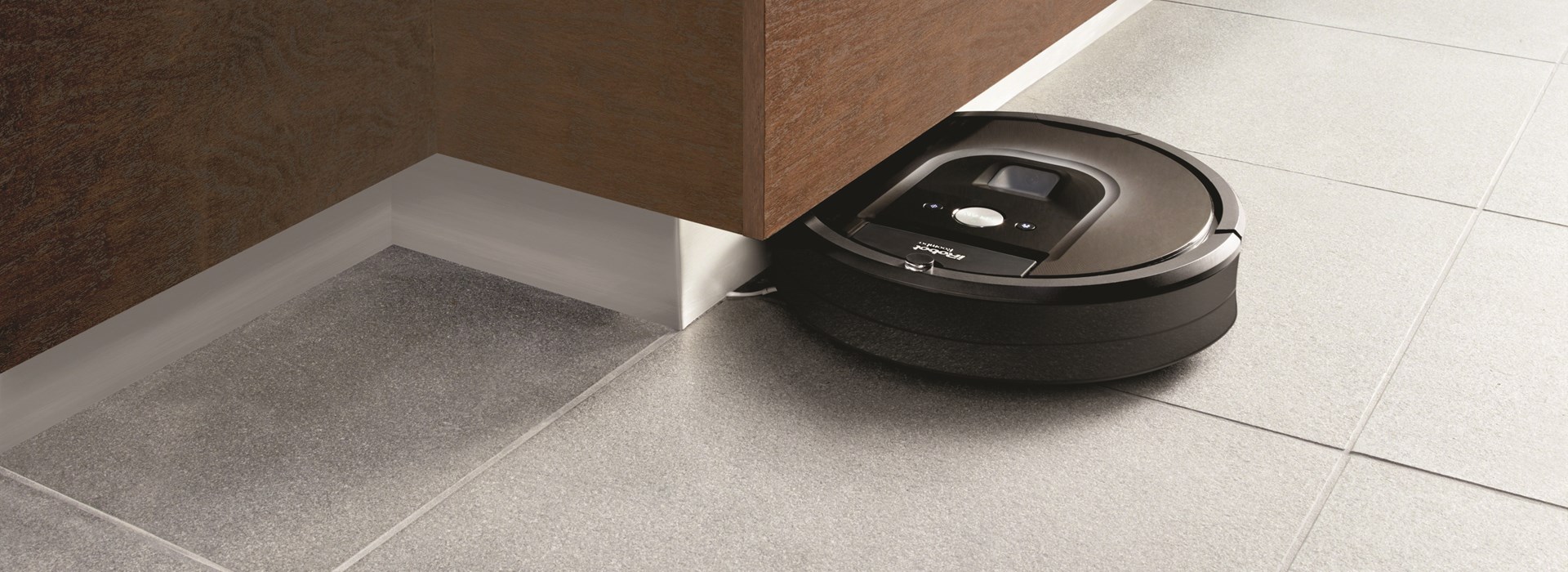 Roomba vacuum cleaner under counter top in kitchen