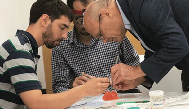 Dr. Van Arsdell working with surgeons-in-training on a simulated cardiac procedure.