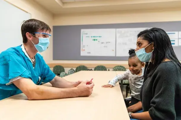 Doctor showing patient 3D printed patient-specific anatomical model