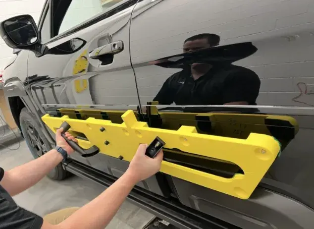 A Subaru engineer uses a 3D printed apply