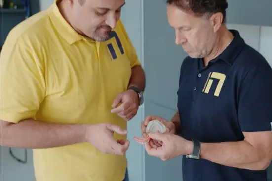 Dental technicians reviewing Stratasys TrueDent dentures