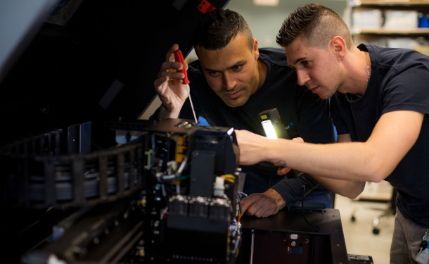 Two men maintaining PolyJet equipment at Stratasys Direct
