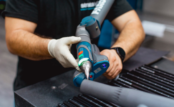 Engineer using portable CMM to inspect 3d printed part at Stratasys Direct