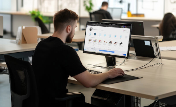 Engineer using computer to order 3d printed parts from RapidQuotes | Stratasys Direct