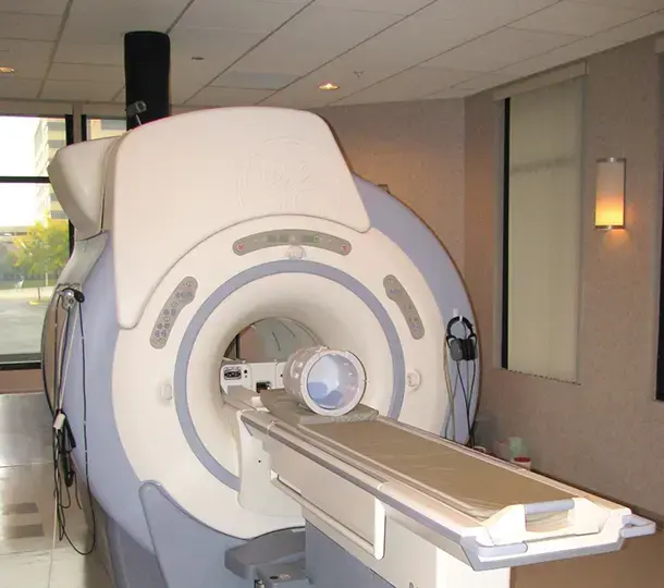 MRI machine with a 3D printed FDM medical device component positioned on the patient table, demonstrating compatibility and use within imaging equipment.