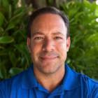 Image of Joe Anguiano, On-Demand Parts Manager at Stratasys Direct, with 17 years of experience in 3D printing and advanced manufacturing, standing confidently in a professional setting.