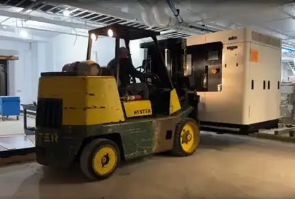 Forklift moving 3D printer for Stratasys Direct in new facility.