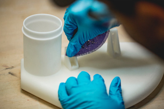 person sanding 3d printed part | Stratasys Direct