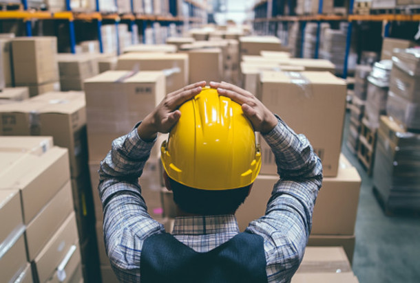 Person frustrated at overcrowded warehouse of supplies due to stockpiling