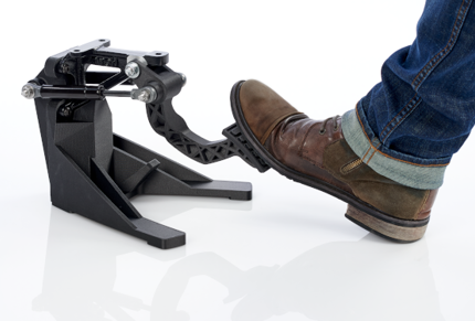 Person stepping on FDM Services 3d printed brake pedal Stratasys Direct